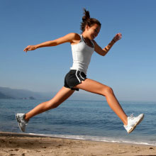 Woman jumping on the beach